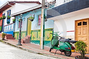 Green motorcycle at the colorful town of Guatape, Antioquia photo